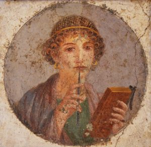 Tondo con affresco romano, del 50 circa, di donna con libro e stilo (cosiddetta "Saffo") proveniente da Pompei (Napoli, Museo archeologico nazionale)